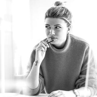 Young woman sitting in office thinking